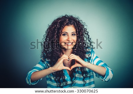Love. Closeup portrait smiling happy young woman making heart sign, symbol with hands isolated green wall background. Positive human emotion expression feeling life perception attitude body language