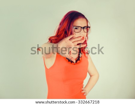 Closeup portrait young angry serious woman showing her denial No Stop talk to hand gesture with palm outward isolated green wall background Negative human emotion face expression feeling body language