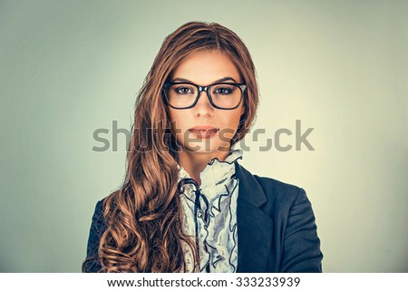 Happy serious young beautiful happy business woman looking at you isolated grey background wall. Closeup confident lawyer teacher office manager. Positive human emotions facial expressions, attitude