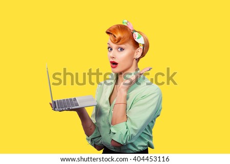 Girl with personal computer. Closeup red head beautiful young woman pretty excited, amazed smiling pinup girl green button shirt holding pc hand up looking at you camera, retro vintage 50\'s hairstyle