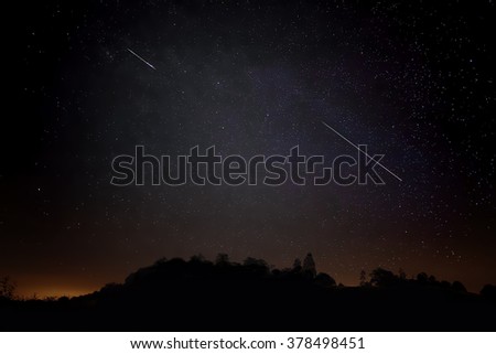 Pair of Meteors. Meteor Shower Night Sky Landscape Silhouette. Shooting Stars