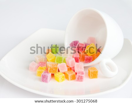 jelly candies in a cup on the white background.