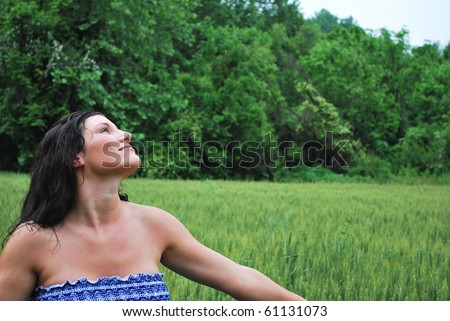 Beautiful woman in a wheat field enjoying the summer rain/Kiss of Summer Rain