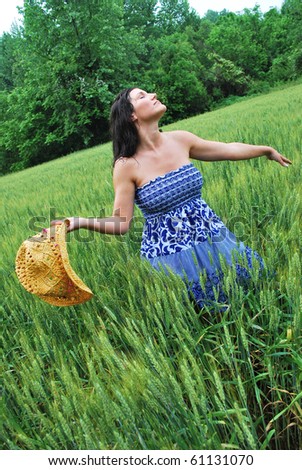 Woman in a wheat field enjoying the summer rain/Kiss of Summer Rain