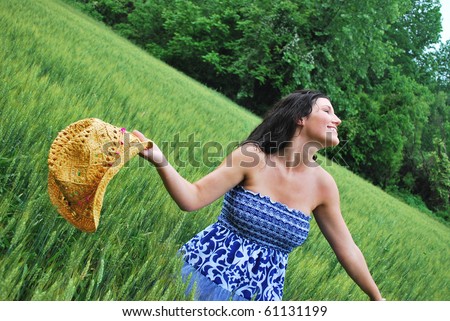 Country Girl in a wheat field enjoying the summer rain/Kiss of Summer Rain