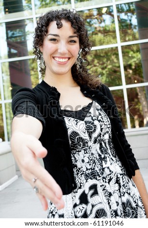 Young woman awaiting a friendly hand shake/Meet and Greet