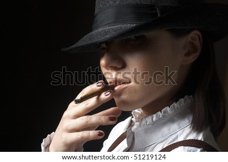 beautiful young woman in hat smoking cigarette