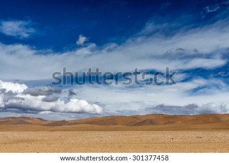 A desert in the Tibet plateau with blue sky and white cloud