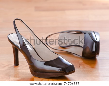 Classic patent leather shoes on wood floor background