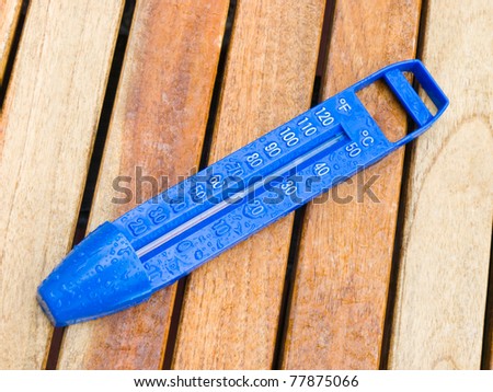 swimming pool thermometer on the wood table