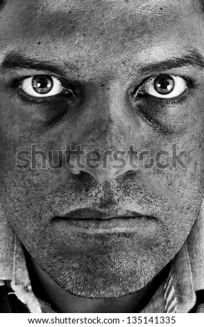 Close up of industrial or coal mine worker, a mid age man, in black and white.