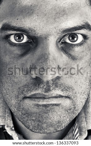 Close up of industrial or coal mine worker, a mid age man, in black and white.