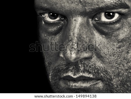 A man depressed showing emotion and evil in the intense eyes. In Black and White.