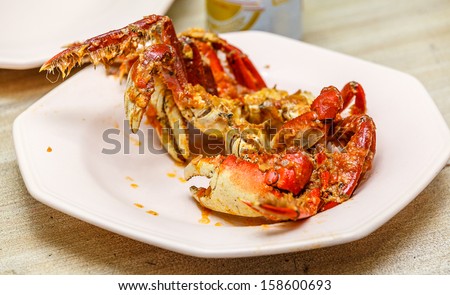Brazilian crab on light pink plate, with tomato sirup and onion. Brazilian sea food.