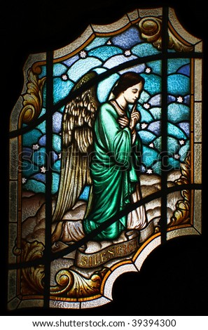 Stained glass of an angel, in the main door or Valongo Church, in Santos, Brazil, asking for silence, with the text 