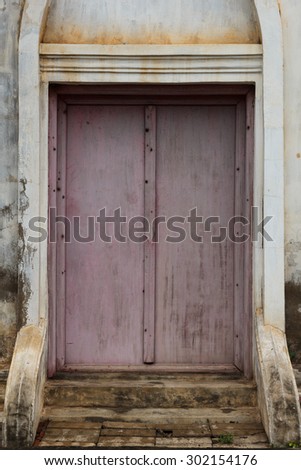 The purple door in white wall.