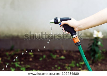 Hosepipe and hand - gardening watering