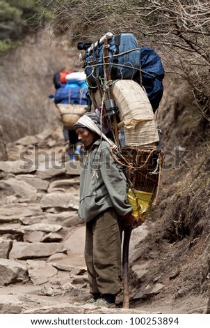 SAGARMATHA NATIONAL PARK, NEPAL - MARCH 06: Porters carry heavy load in the Himalaya in time of Russian expedition on March 06, 2010 in Sagarmatha National Park, Nepal