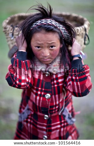 DHO TARAP, NEPAL - SEPTEMBER 10: Tibetan girl Shime, 9, from the village of refugees poses for a photo during the Dho Tarap Full Moon Festival on September 10, 2011 in Dho Tarap Village, Dolpo, Nepal