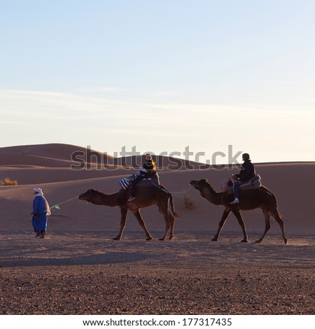 ERG CHEBBI, MOROCCO - JANUARY 06: Caravan of tourists crossing in desert on January 06, 2014 in Western Sahara, Morocco. Tourism is an important item in the economy of Morocco