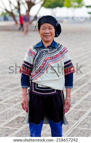 YUANYANG, CHINA - MAY 04: Unidentified Hani woman in national clothes poses for a photo during Yuanyang festival on May 04, 2014 in Yuanyang, China.