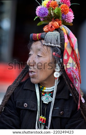 LEH, INDIA - JUNE 14: An unidentified Ladakhi woman in national clothes poses for a photo during Yuru Kabgyat festival on June 14, 2012 in Lamayuru, North India