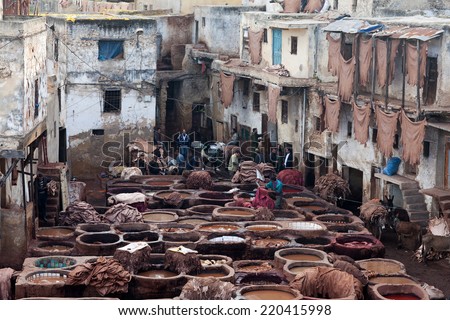 FEZ, MOROCCO - JANUARY 04: Workers in the tannery souk of weavers on January 04, 2014 in Fez, Morocco. The tannery souk of weavers is the most visited part of the 2000 years old city.