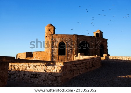 Essaouira Fortress, Morocco. Essaouira is a city in the western Moroccan economic region of Marrakech Tensift Al Haouz, on the Atlantic coast. It has also been known by its Portuguese name of Mogador.