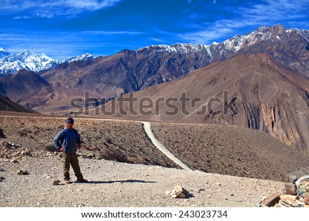 MUSTANG, ANNAPURNA CONSERVATION AREA, NEPAL - DECEMBER 26: Trekker on the road from Muktinath to Jomsom, a part of Annapurna Circuit trek on December 26, 2009 in Annapurna conservation area, Nepal.