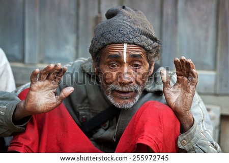 KATHMANDU, NEPAL - JANUARY 08: An unidentified Nepalese man seeking alms on the street on January 8, 2010 in Kathmandu, Nepal