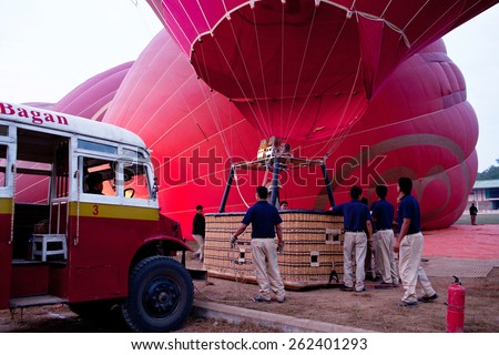 BAGAN, MYANMAR - JANUARY 7: Men holding hot air balloon - proper training to fly a balloon on January 7, 2011 in Bagan, Myanmar. Ballooning over Bagan is one of the most memorable action for tourists.