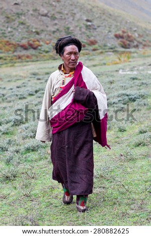 DHO TARAP, DOLPO, NEPAL - SEPTEMBER 11: Ngakpa man in traditional clothes waiting for Puja ceremony during Dho Tarap Full Moon Festival on September 11, 2011 in Dho Tarap village, Nepal.
