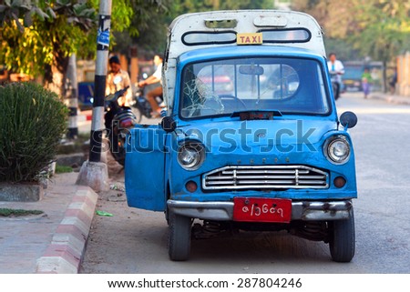 MANDALAY, MYANMAR - JANUARY 11: Blue taxi (mini pick-up trucks, with two very small benches on the back) on the street on January 11, 2011 in Mandalay, Myanmar.