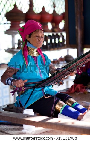 BAGAN, MYANMAR - JANUARY 9: Padaung tribe woman working in a textile mill on January 9, 2012 in Bagan, Myanmar. Padaung is a Shan term for the Kayan Lahwi people.