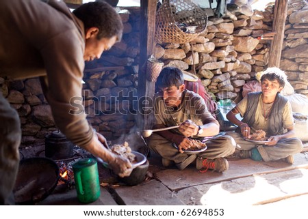 MANASLU AREA, NEPAL - NOVEMBER 20: Nepalese porters eating porrige \