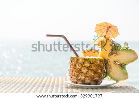 Pineapple cocktail with beautiful sea in background