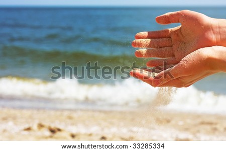 Hands playing with sand