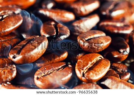 Coffee beans with smoke. Macro.
