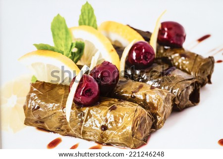 Turkish traditional food, Grape leaf dolma or yaprak sarma - stuffed with meat and rice and garnished with olives and lemon