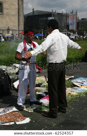 MEXICO CITY - JULY 28: Unknown people executing amerindian rituals in the square in front of Mexico City Cathedral and Metropolitan Tabernacle, Mexico City, Mexico, on 28 July 2010.