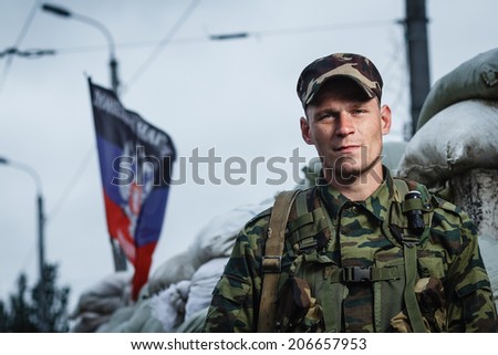 DONETSK, UKRAINE - JUNE 27: One of the fighters at the Russian Orthodox Army\'s block post on the road to the airport on june 27, 2014 in Donetsk.