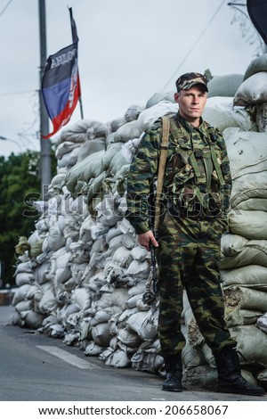 DONETSK, UKRAINE - JUNE 27: One of the fighters at the Russian Orthodox Army\'s block post on the road to the airport on june 27, 2014 in Donetsk.