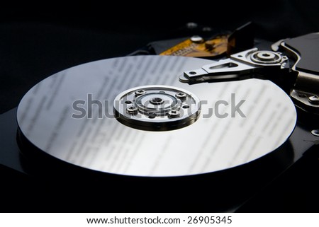 hard disk drive on black background with reflection to represent data