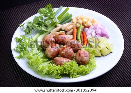 Thai food - East-Northern Thai Grilled Rice Sausages (Fermented sausage) with lime, Chili, Bean, ginger, shallots. It\'s called Sai Krok Isan
