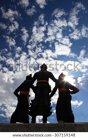 Silhouette Behind Three Kings Monument in the center of Chiang Mai, Thailand. The sculpture of the three kings is a symbol of Chiang Mai.