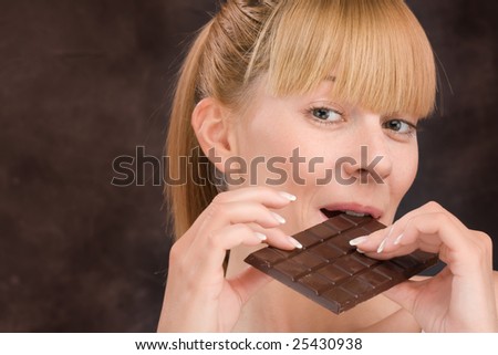 Blond girl hold dark chocolate with smile on the face