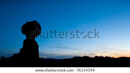 Silhouetted against a beautiful sunset, Balanced Rock in Arches National Park, Utah.