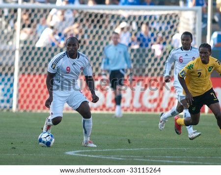 CARSON, CA. - JULY 3: Concacaf Gold Cup soccer match, Canada vs. Jamaica at the Home Depot center in Carson. Ali Gerba dribbles the ball with Julian de Guzman and Jason Morrison in the background on July 3, 2009.