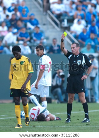 CARSON, CA. - JULY 3: Concacaf Gold Cup soccer match, Canada vs. Jamaica at the Home Depot center. Demar Phillips gets a yellow card as William Johnson lays on the floor and Paul Stalteri looks on on July 3, 2009.