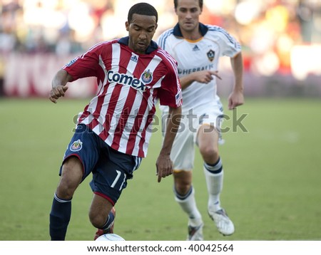CARSON, CA. - NOVEMBER 1: Maykel Galindo (L) dribbles away from Todd Dunivant (R) during the match of Chivas USA vs. Los Angeles Galaxy at the Home Depot Center on November 1, 2009 in Carson.